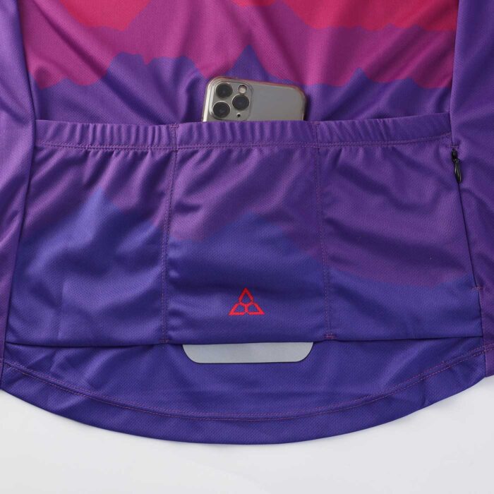 Close up showing 3 pouch pockets; one with a mobile phone in it