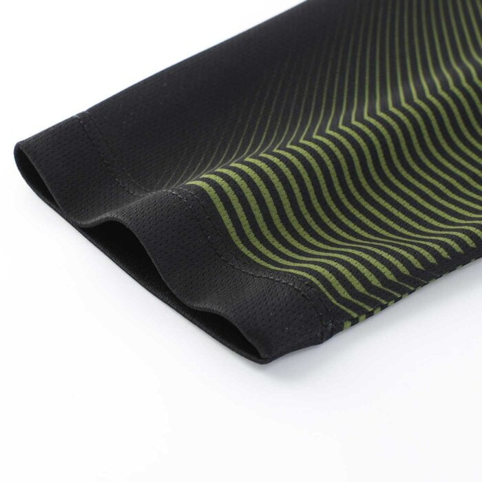 Close up of the end of a sleeve on a green and black striped cycling top
