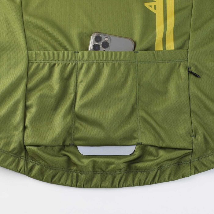 Close up photograph showing the lower back of a cycling jersey with 3 pouch pockets, one zippered pocket and a reflective tab
