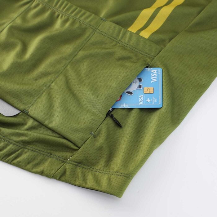 Close up of zippered pocket on the rear of an olive green cycling top