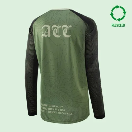 Rear view of a long-sleeved mountain bike top with a 3 letter logo across the upper back, and a circular recycled logo in the top right of the image